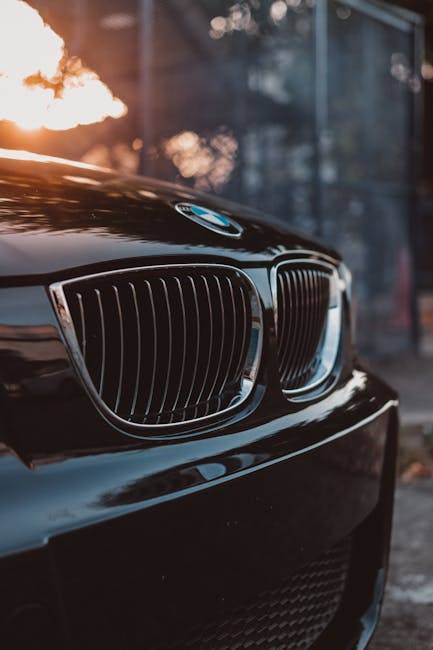 吸引力法則成功案例:人生第一輛車的秘密!Stylish luxury car grille in focus with sunset reflections, showcasing automotive elegance.